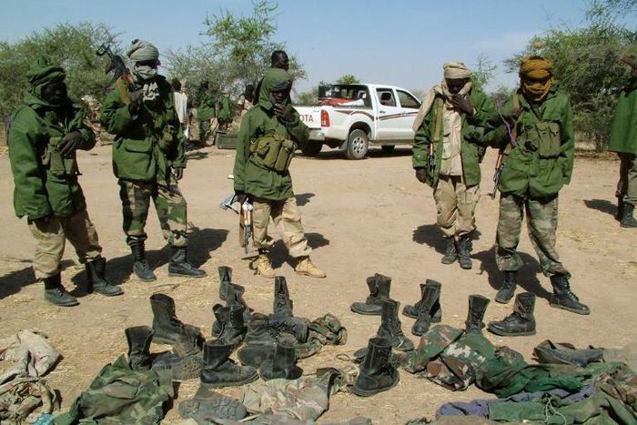 Chadian army soldiers (pictured 2006) look at recovered uniforms from rebel soldiers led by Mahamat Nouri, who was charged with crimes against humanity in Paris