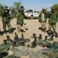 Chadian army soldiers (pictured 2006) look at recovered uniforms from rebel soldiers led by Mahamat Nouri, who was charged with crimes against humanity in Paris