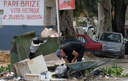 A man collects recyclable items in the impoverished Tunis suburb of Ettadhamen where unemployment is around 18 percent compared to a nationwide level of 15 percent