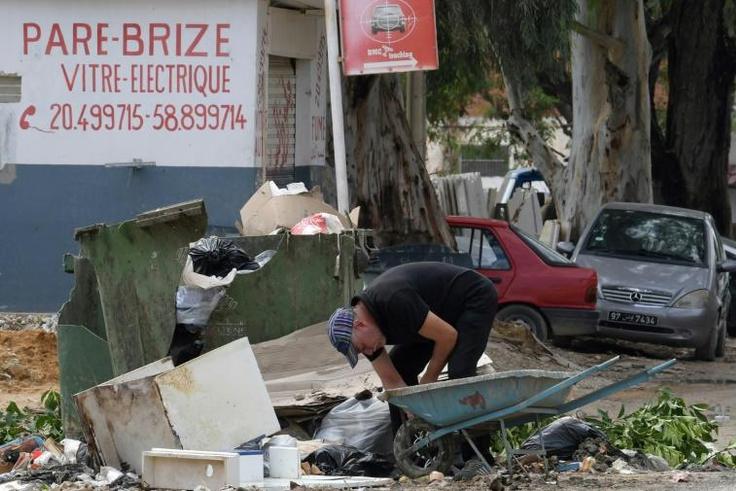 A man collects recyclable items in the impoverished Tunis suburb of Ettadhamen where unemployment is around 18 percent compared to a nationwide level of 15 percent