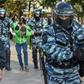Russian National Guard officers detain protesters following a rally calling for fair elections in Moscow
