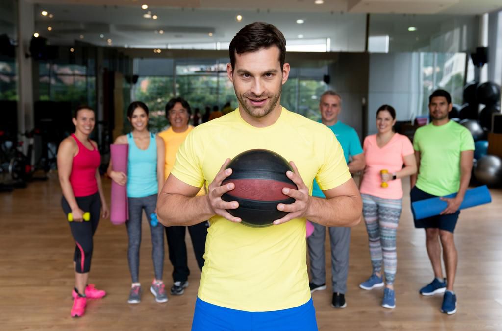 Personal trainer at the gym with a group