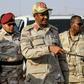 Mohamed Hamdan Dagalo (C), deputy head of Sudan's ruling Transitional Military Council (TMC) and commander of the Rapid Support Forces (RSF) paramilitaries, is escorted through the village of Qarri, north of Khartoum, on June 15, 2019