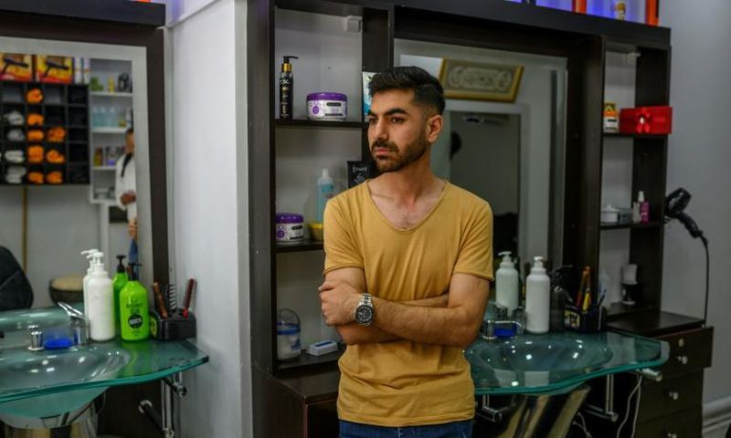 Ahmad Yassine in his Istanbul barbershop where he watched as a crowd attacked his and other Syrian-owned businesses