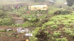 Mbukinya bus full of passengers rolls off the Kinungi black spo