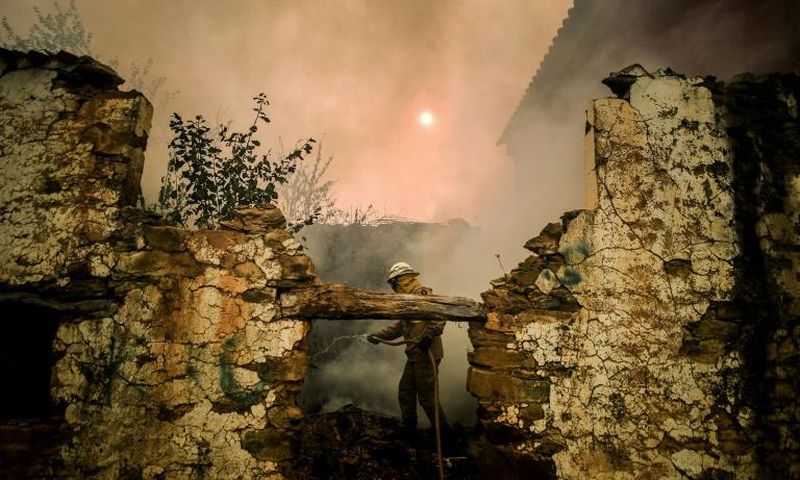 A National Guard firefighter helps battle a wildfire in the village of Roda in central Portugal on July 21