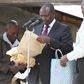 File image of DP Ruto holding cash donations at a past harambee