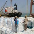 Yemenis receive sacks of food aid packages from the World Food Programme (WFP) in the Yemeni port city of Hodeida on June 25, 2019