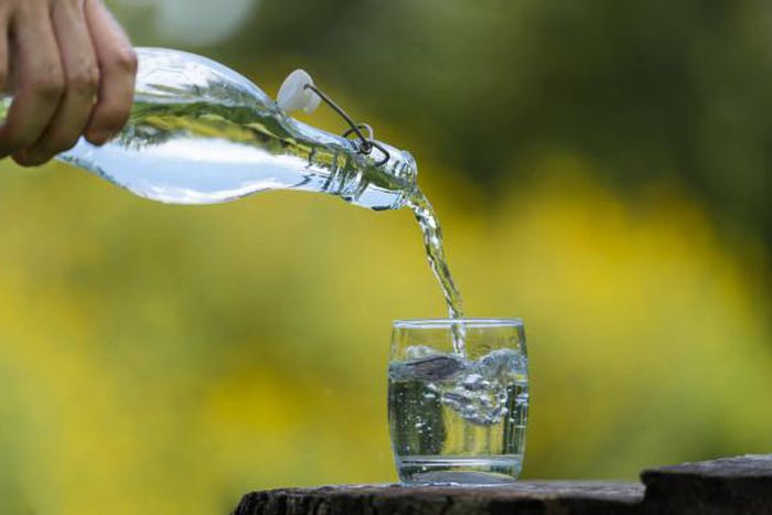 Pouring water in a glass