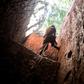 A subsistence miner in Mabakulu, eastern DR Congo, clambers out of a mine shaft with the help of a vine. Safety in Congo's illegal mining sector is poor, and accidents are frequent (file picture)