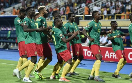 Cameroon's forward Stephane Bahoken (R) celebrates his goal