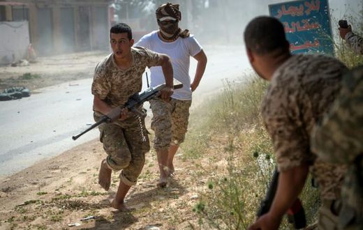 Fighters loyal to Libya's internationally recognised unity government run for cover during recent clashes with the self-styled Libyan National Army
