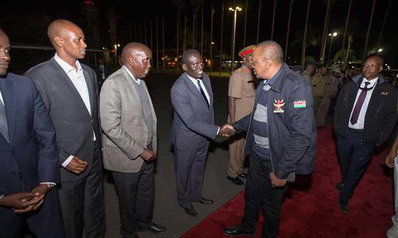 File image of President Uhuru Kenyatta at Jomo Kenyatta International Airport during a past foreign trip