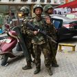 Paramilitary police stand guard outside a shopping mall in Hotan, in China's western Xinjiang region, which has seen an uptick in violence in recent years