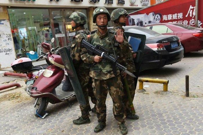 Paramilitary police stand guard outside a shopping mall in Hotan, in China's western Xinjiang region, which has seen an uptick in violence in recent years