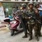 Paramilitary police stand guard outside a shopping mall in Hotan, in China's western Xinjiang region, which has seen an uptick in violence in recent years