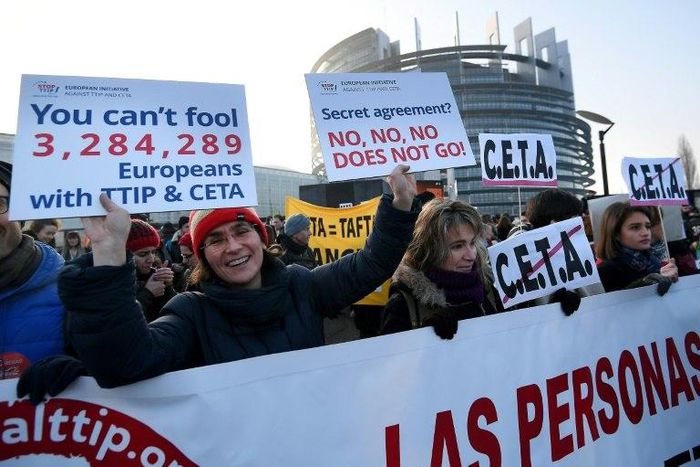 Protestors demonstrate against the EU-Canada trade deal outside the European Parliament in Strasbourg, France