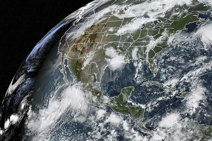 This satellite image obtained from NOAA/RAMMB, shows Hurricane Lorena (L) on September 19, 2019 as it made landfall on the southwest coast of Mexico