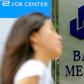 Iran has claimed a "victory" after one of its banks received compensation from British authorities over "illegal" sanctions; in a file picture taken on September 8, 2010 a woman walks past a signboard of Bank Mellat, an Iranian state-run commercial ban...