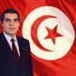 A picture released in April 1998 of Tunisia's ousted president Zine el-Abidine Ben Ali posing for an official picture in front of the Tunisian flag