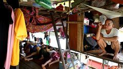 Vietnamese migrant workers living on Hanoi's Red River rise before dawn to buy fruit wholesale before heading to a market