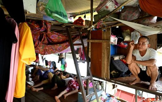 Vietnamese migrant workers living on Hanoi's Red River rise before dawn to buy fruit wholesale before heading to a market