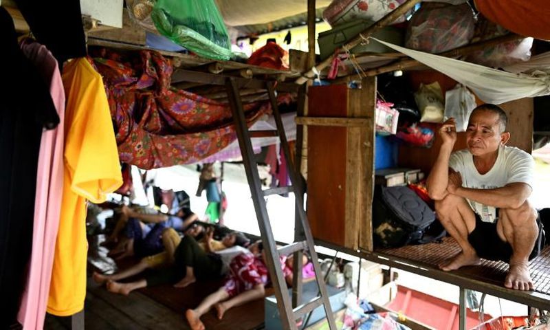 Vietnamese migrant workers living on Hanoi's Red River rise before dawn to buy fruit wholesale before heading to a market