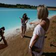 A young woman poses for pictures by the ash dump site -- nicknamed the local "Maldives" -- but what appears a tropical paradise is actually a toxic lake