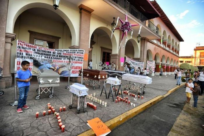 Residents posed with symbolic coffins to protest against violence and organized crime after the January 2015 killings in Apatzingan