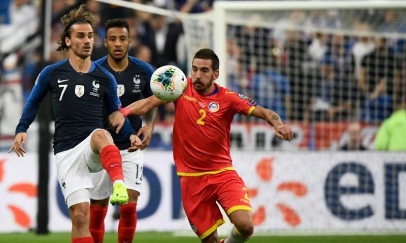 Antoine Griezmann (L) missed a penalty but later set up a goal as France eased to a 3-0 win over lowly Andorra in Euro 2020 qualifying