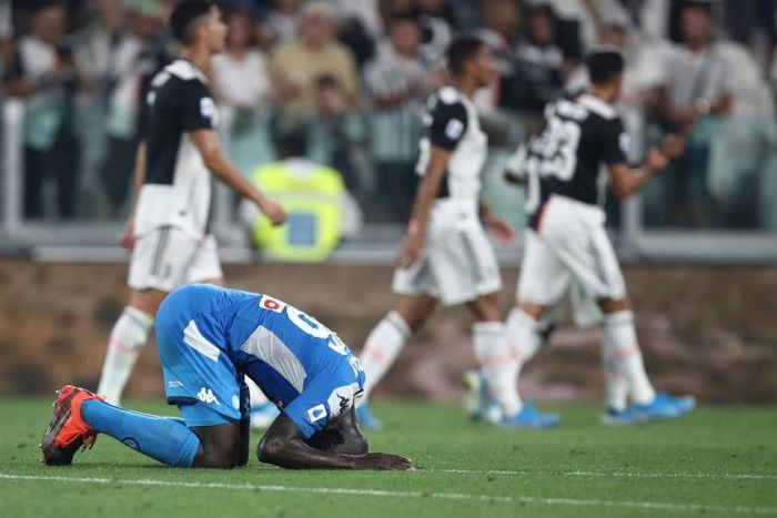 Napoli's Senegalese defender Kalidou Koulibaly reacts after scoring an own goal during the Italian Serie A football match Juventus vs Napoli at the Juventus stadium in Turin