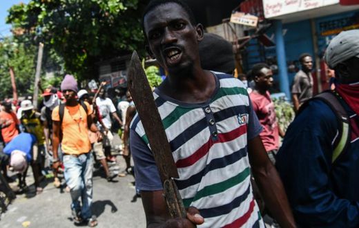 A demonstrator marches to demand the resignation of President Jovenel Moise, in Port-au-Prince, Haiti, on September 27, 2019
