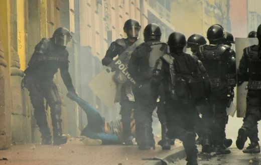 Riot police arrest a demonstrator during a protest following the announcement of a transport strike against Ecuadorean President Lenin Moreno's government economic policies