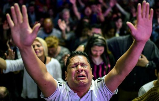 Followers participate in a religious service at the Manantial de Bendiciones Evangelical church in San Martin, Buenos Aires province