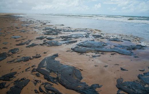 A handout picture released by the Sergipe State Environment Administration on September 25, 2019, shows oil spilled on a beach in Pirambu, Sergipe state, Brazil