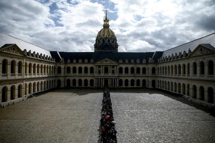 A massive queue snaked around the Invalides complex to pay homage at Jacques Chirac's coffin ahead of a national day of mourning on Monday