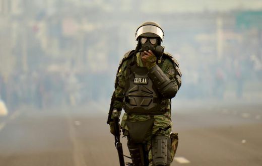 A soldier takes up position during clashes with indigenous people and farmers protesting against fuel hikes introduced by Ecuador's President Lenin Moreno, on the outskirts of Quito