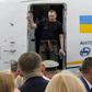 He flashed a victory sign as he disembarked