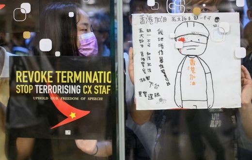Protesters stuck posters outside a shopping mall in an August rally to support Cathay Pacific staff in Hong Kong