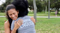 She embraces a pal donning a BackGetters tee.