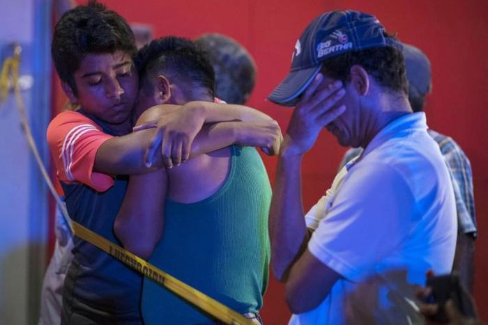 People try to console each other after 25 died in a fire in a bar in Mexico's violent Veracruz state