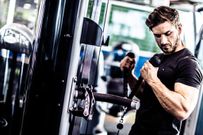 Muscular Fit Man Exercising in a Gym