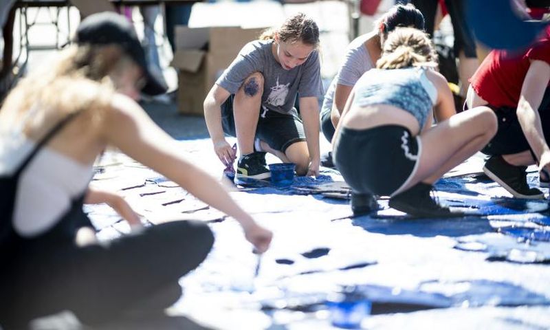 Nora Gell (center), 14, paints cardboard waves in Brooklyn on September 15, 2019 for the climate strike protests planned for September 20
