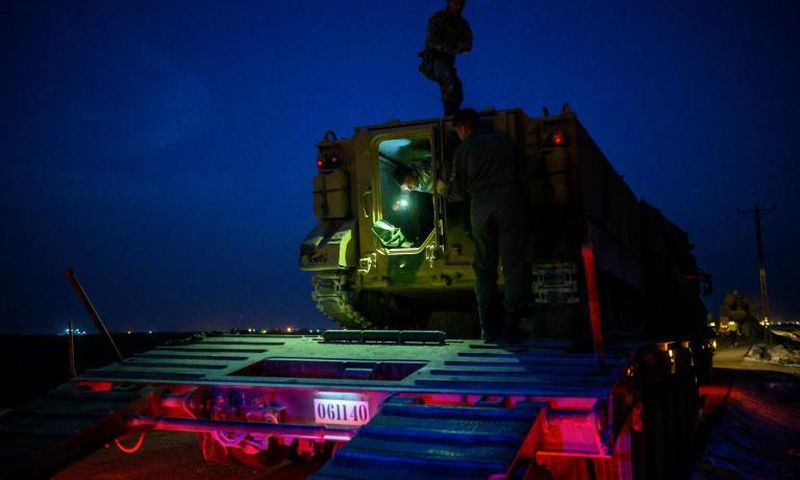 Turkish troops keep up their build-up along the Syrian border though the night as the government promises a long-threatend assault on the Kurdish-ruled northeast will begin "soon"