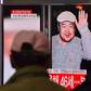 People watch a television news report in a Seoul railway station on the death of Kim Jong-Nam, the half-brother of North Korean leader