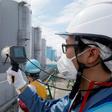 Staff measure radiation levels around the storage tanks of radiation-contaminated water at the tsunami-crippled Tokyo Electric Power Company (TEPCO) Fukushima Dai-ichi nuclear power plant in Japan