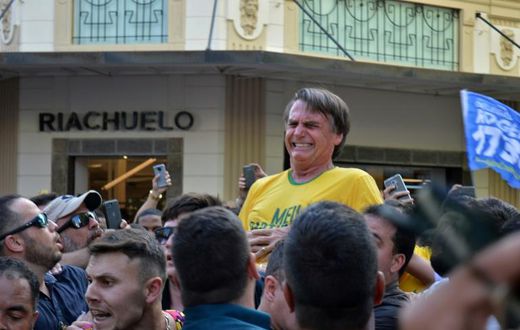 Brazil's then-presidential candidate Jair Bolsonaro grimaces after being stabbed during a campaign rally in Juiz de Fora, in southern Brazil, on September 6, 2018