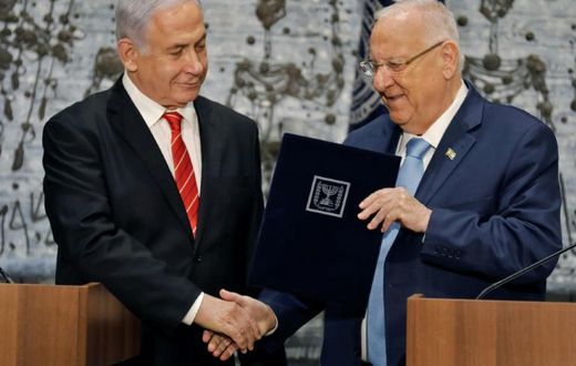 Israeli President Reuven Rivlin gives veteran incumbent Benjamin Netanyahu the potentially impossible task of forming a majority coalition while battling the looming threat of corruption charges