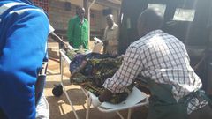 File image of a casualty being led out of a crime scene. 2 people suffer serious injuries after chang'aa boiler exploded in Machakos
