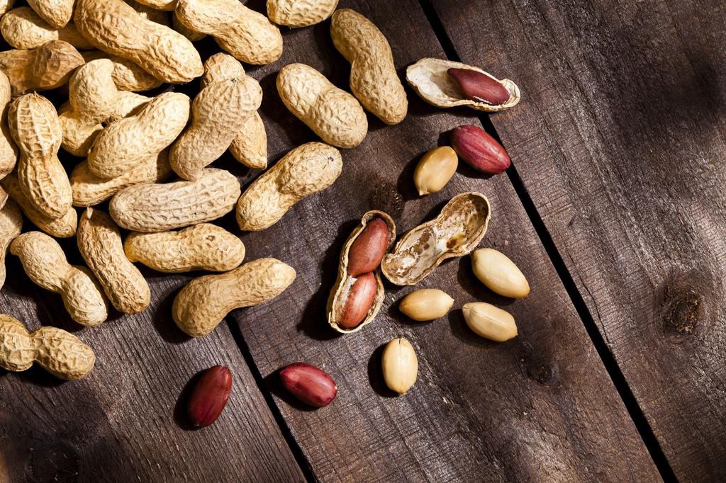 Peanuts on rustic wood table
